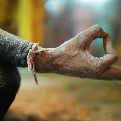 Close-up of hands in a specific mudra gesture.